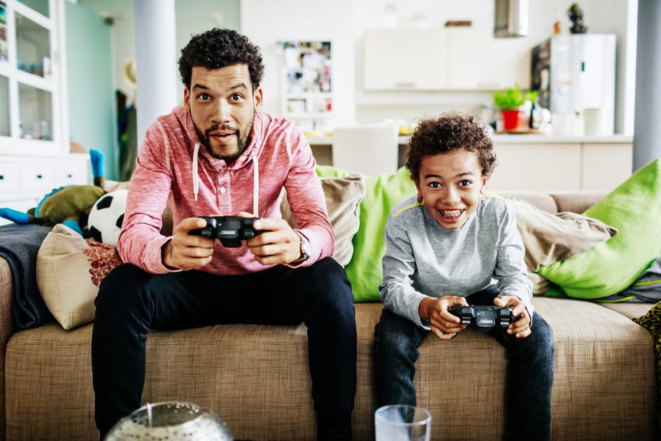 Father and Son on couch playing video games